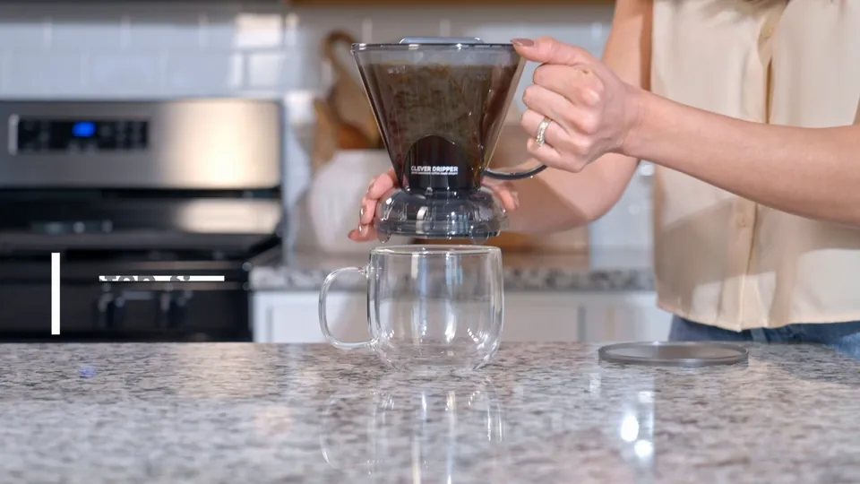 Coffee pouring from a Clever Dripper into a glass mug